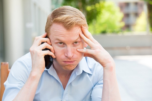 Homme exaspéré au téléphone